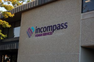 Incompass Logo On Building