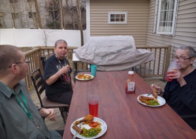 Group Home Members Eating A Meal